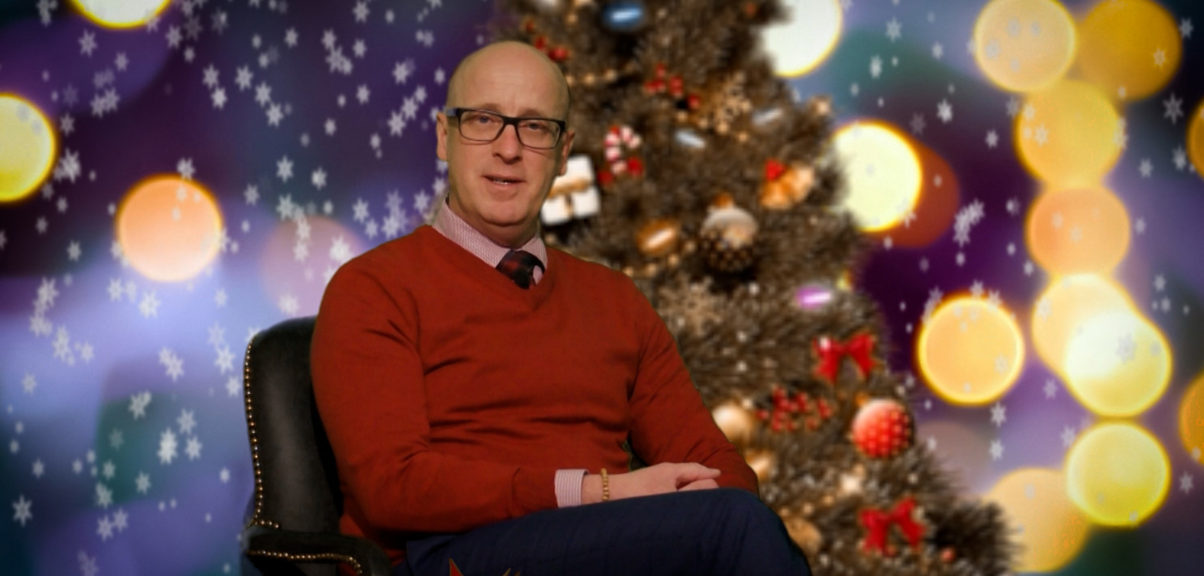 ATA president Jason Schilling seated in a red sweater in front of a Christmas tree