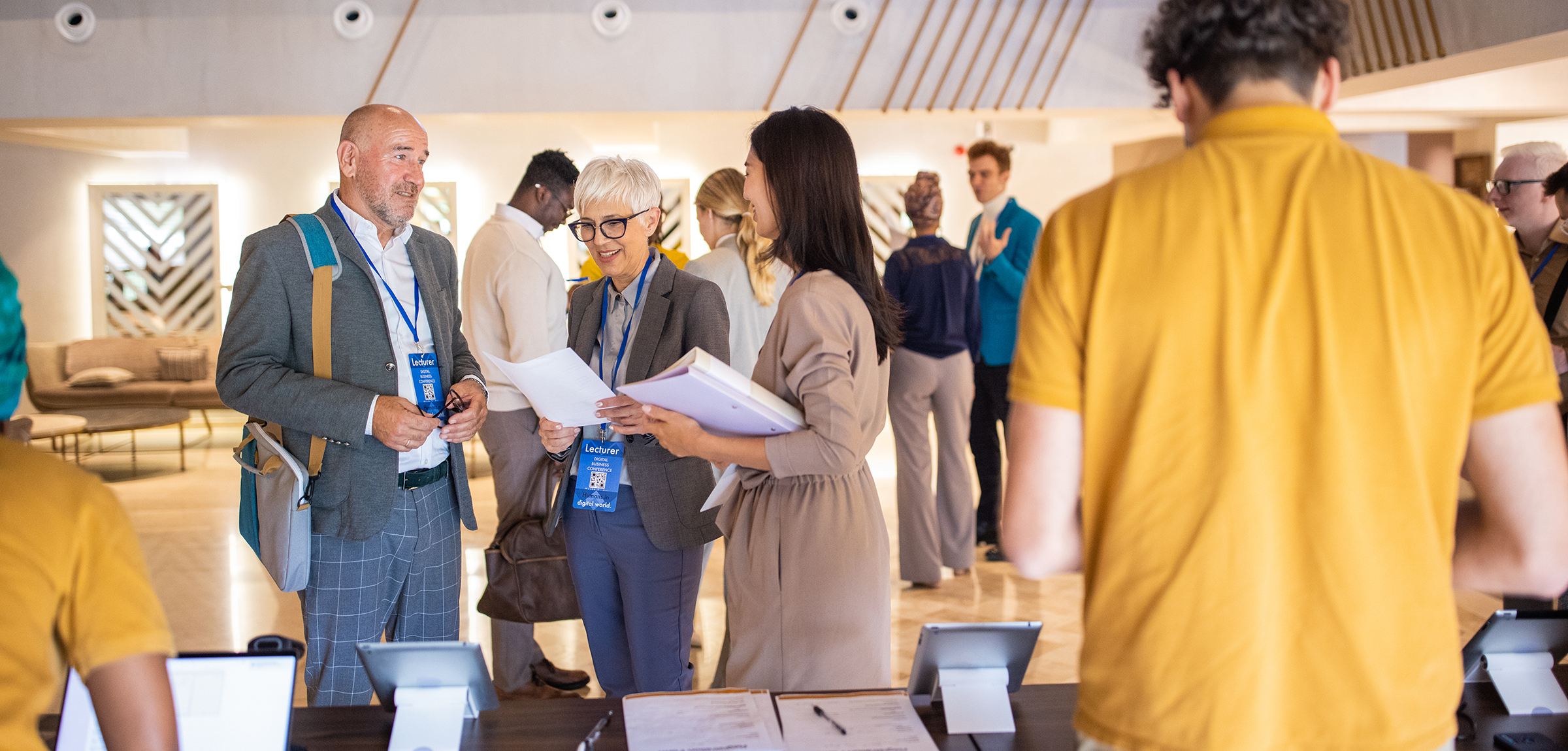 Three peoples standing at a registration desk