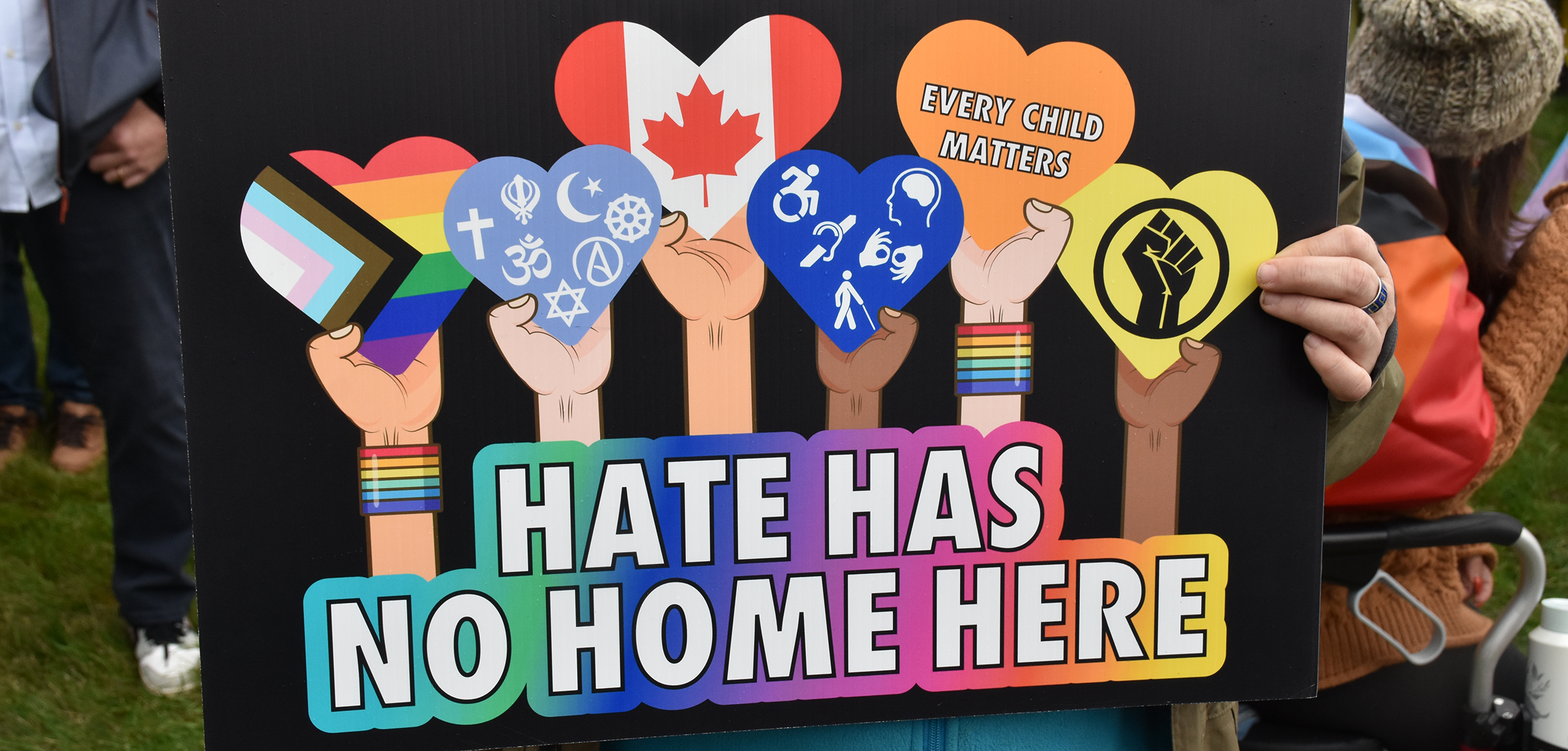 Poster of 6 raised arms holding hearts depicting different types of diversity concerns and the text below saying "Hate has no home here" 