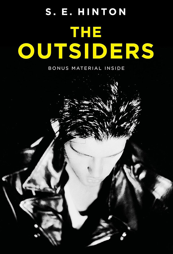 Black and White image of young man in leather coat, and book title "The outsiders" in bold yellow text