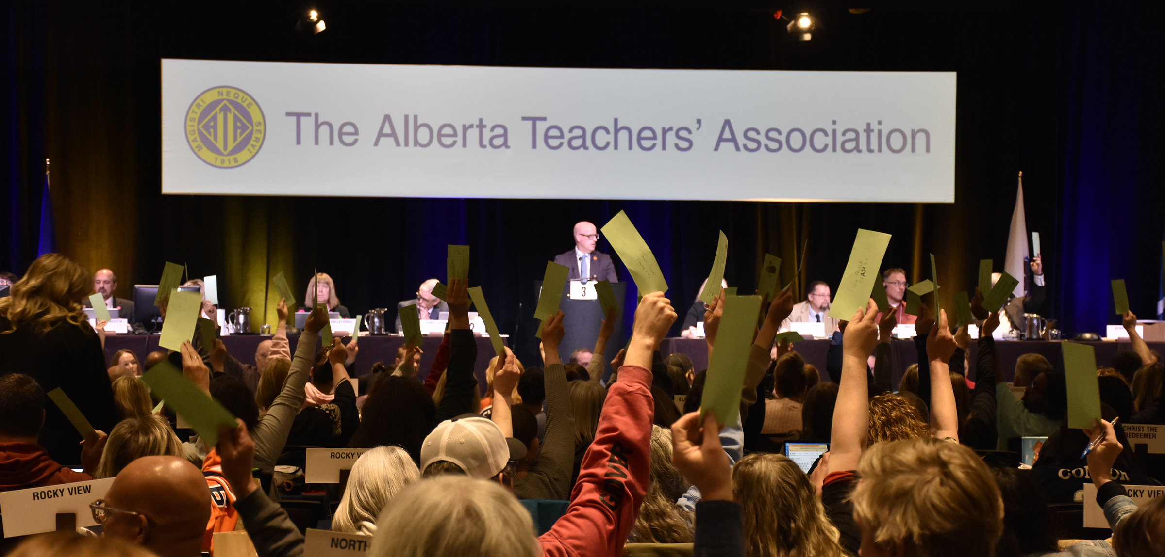 ARA attendees hold up voting signs