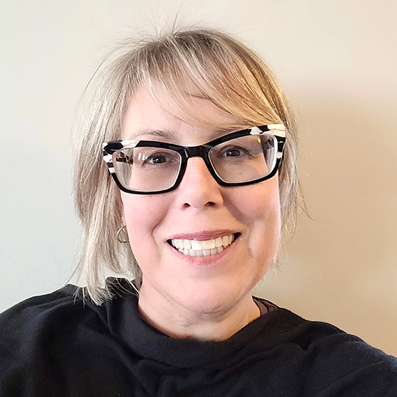 Selfie of blond women with black cat framed glasses