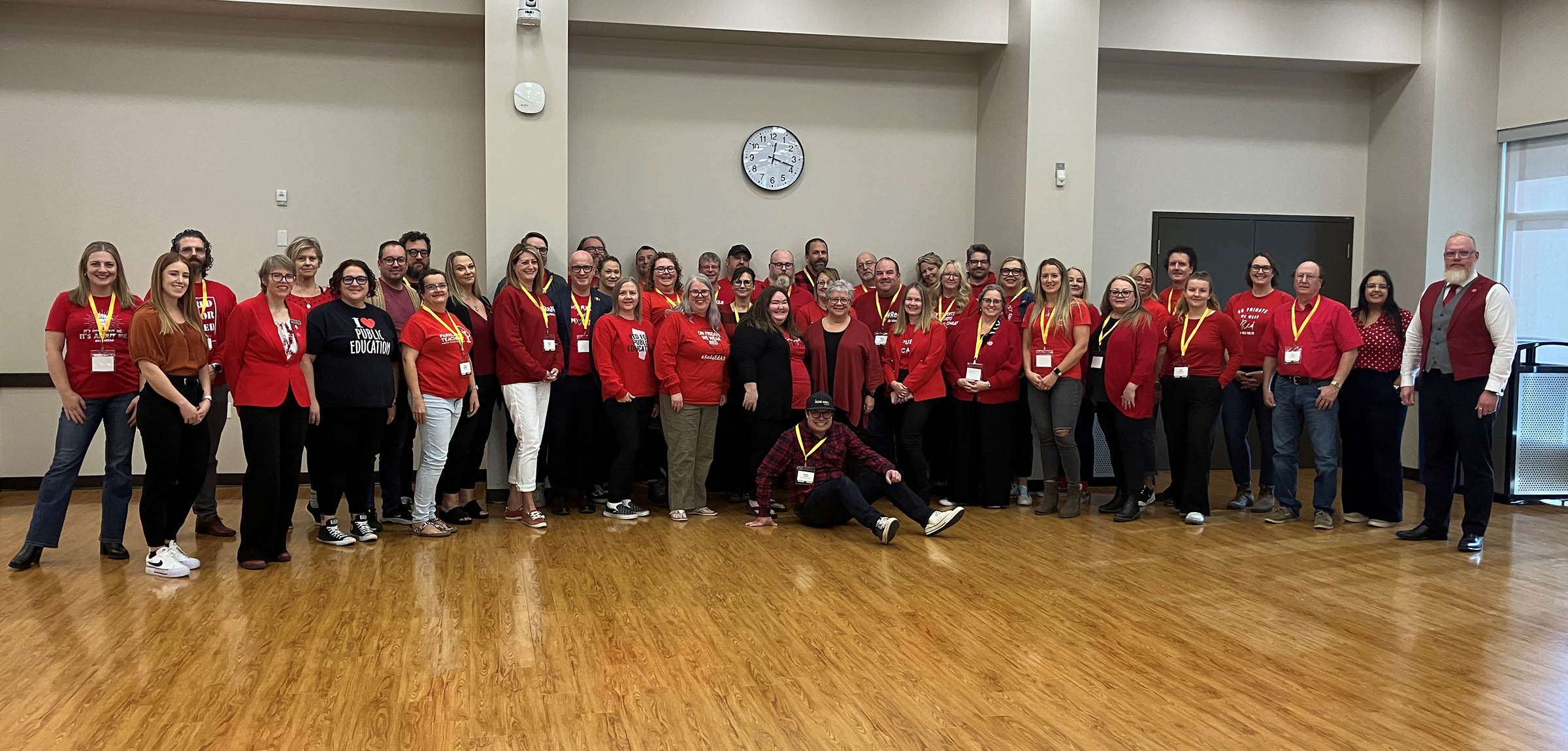 group of 25 people wearing red shirts in the ATA's auditorium