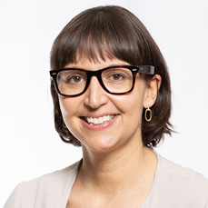 Women with short dark bob wearing glasses