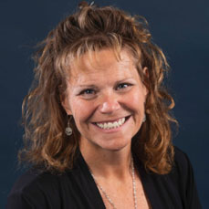 Portrait of a brunette curly haired women with bangs