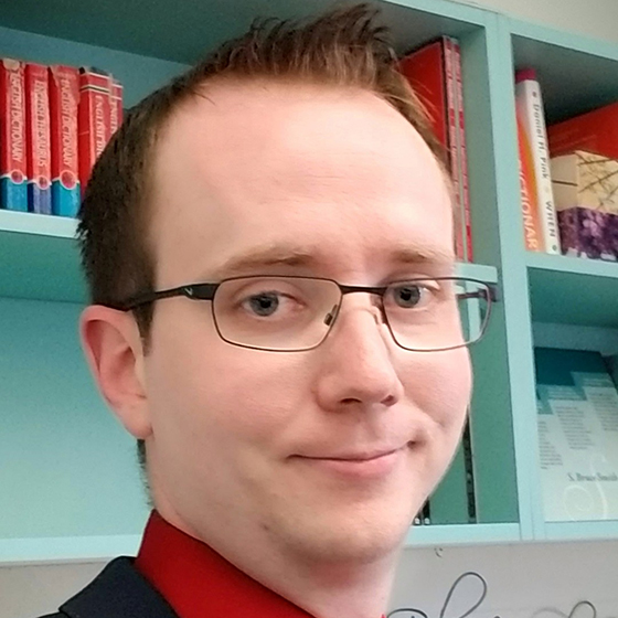 Portrait of red haired man in a red shirt