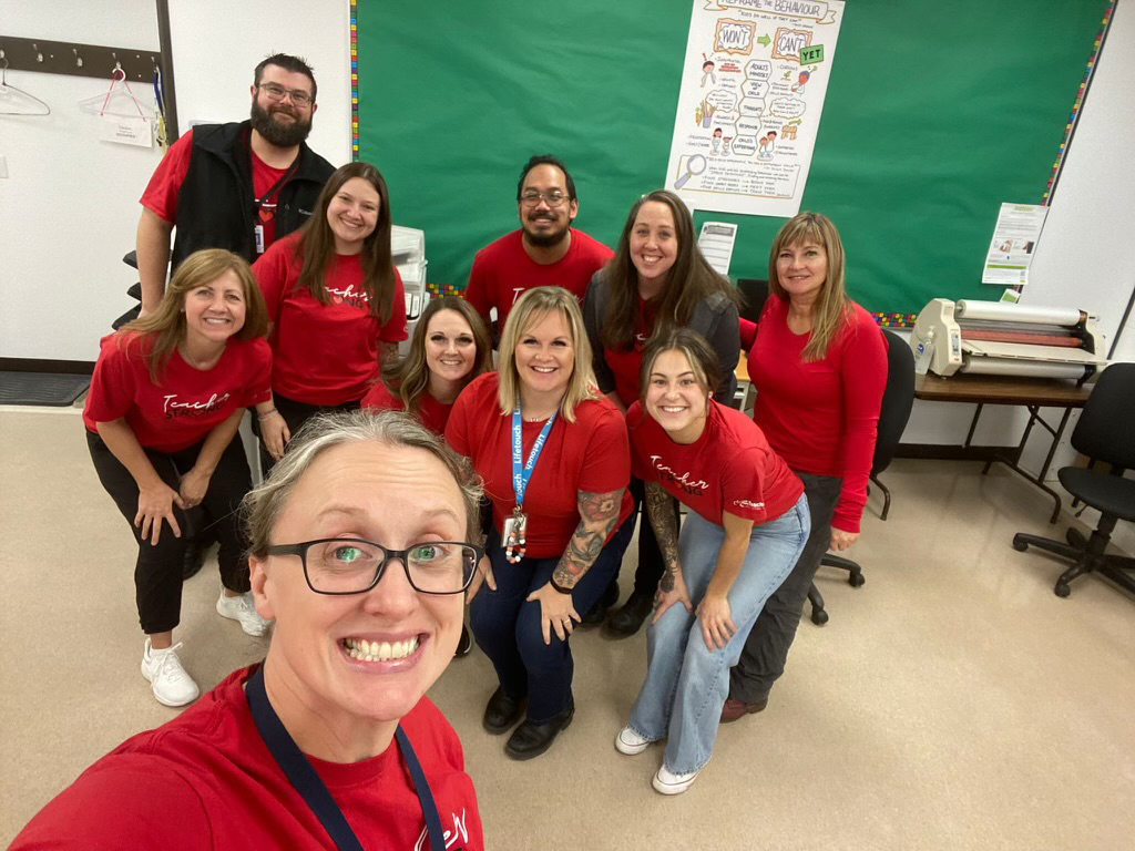 Teachers taking a selfie wearing red for ed shirts