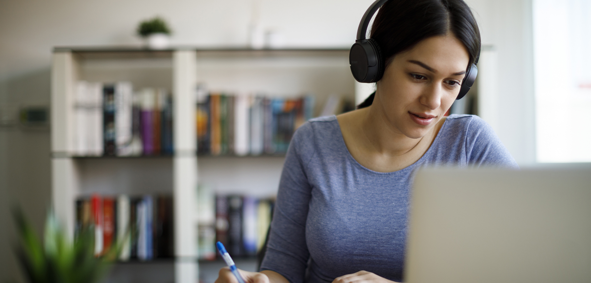 women with headphones on laptop