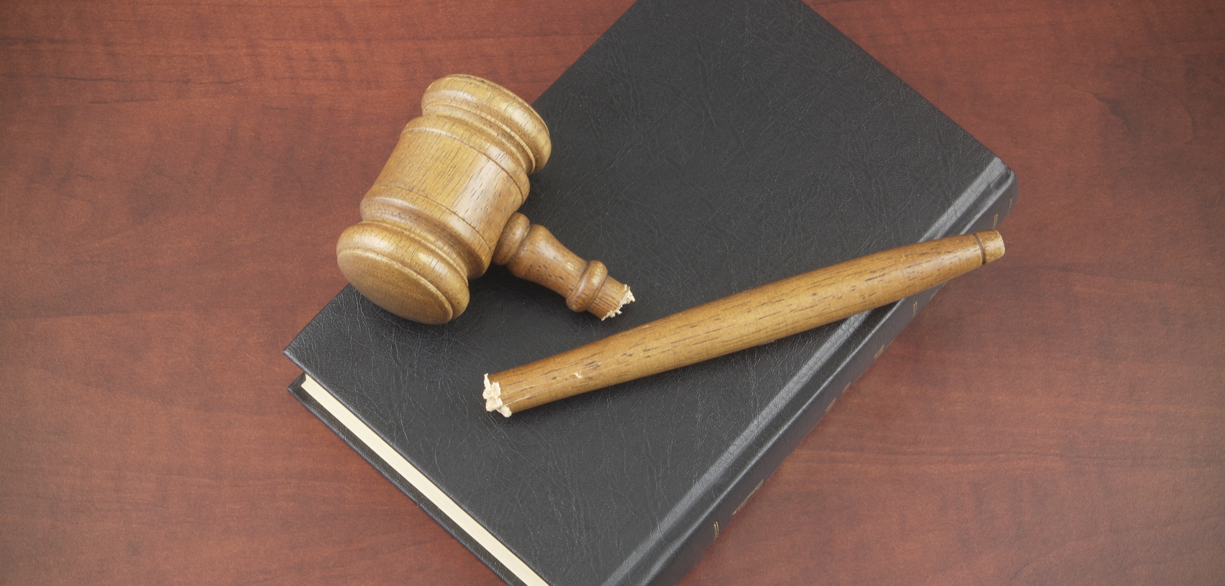 broken gavel on top of a book