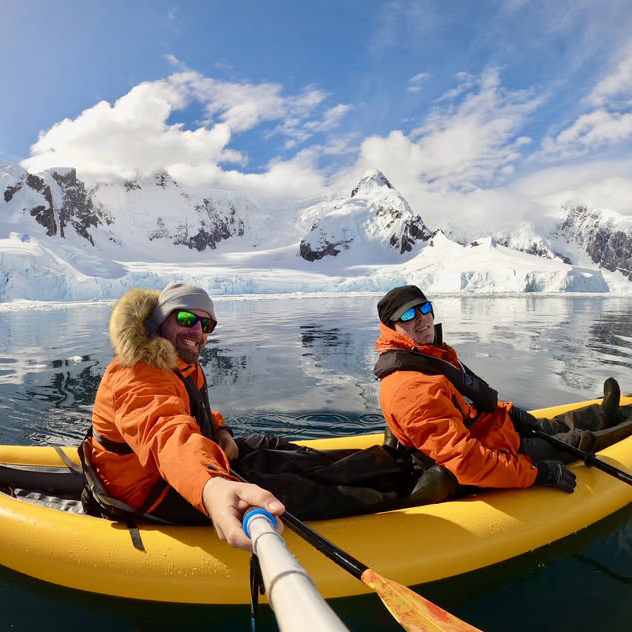 Two men on a kayak taking a selfie