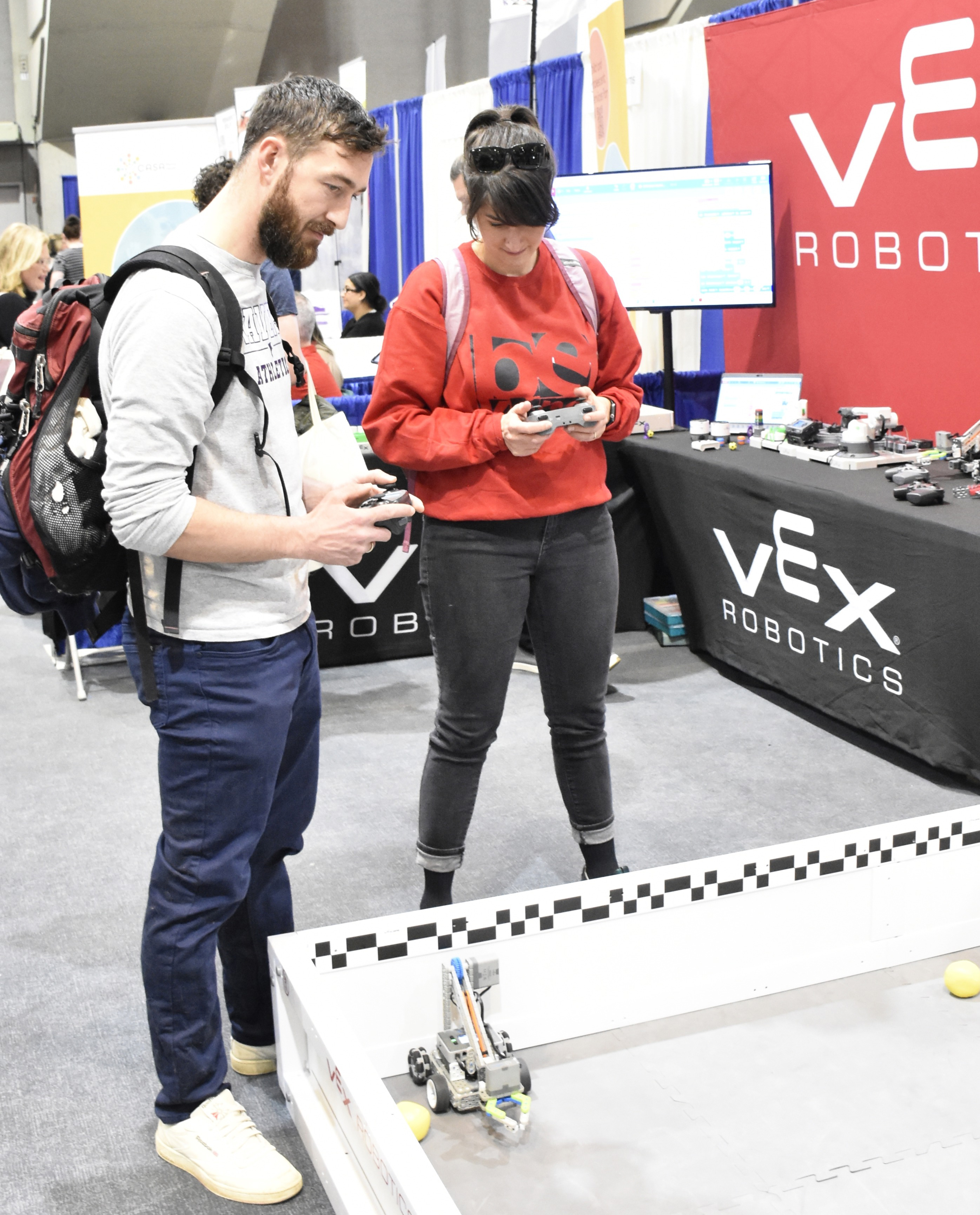 Two people operating a remote controlled vehicle