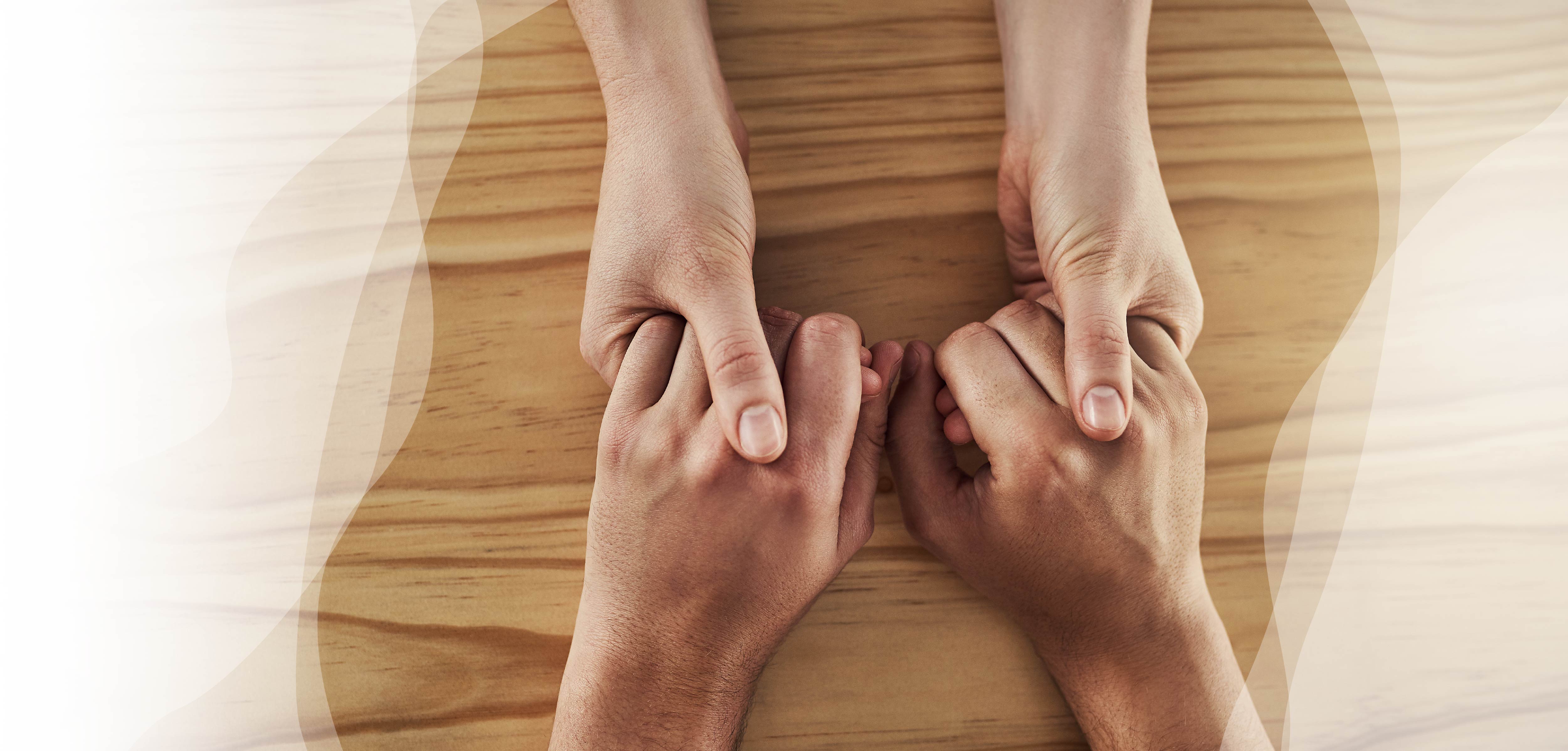 Holding hands over tabletop