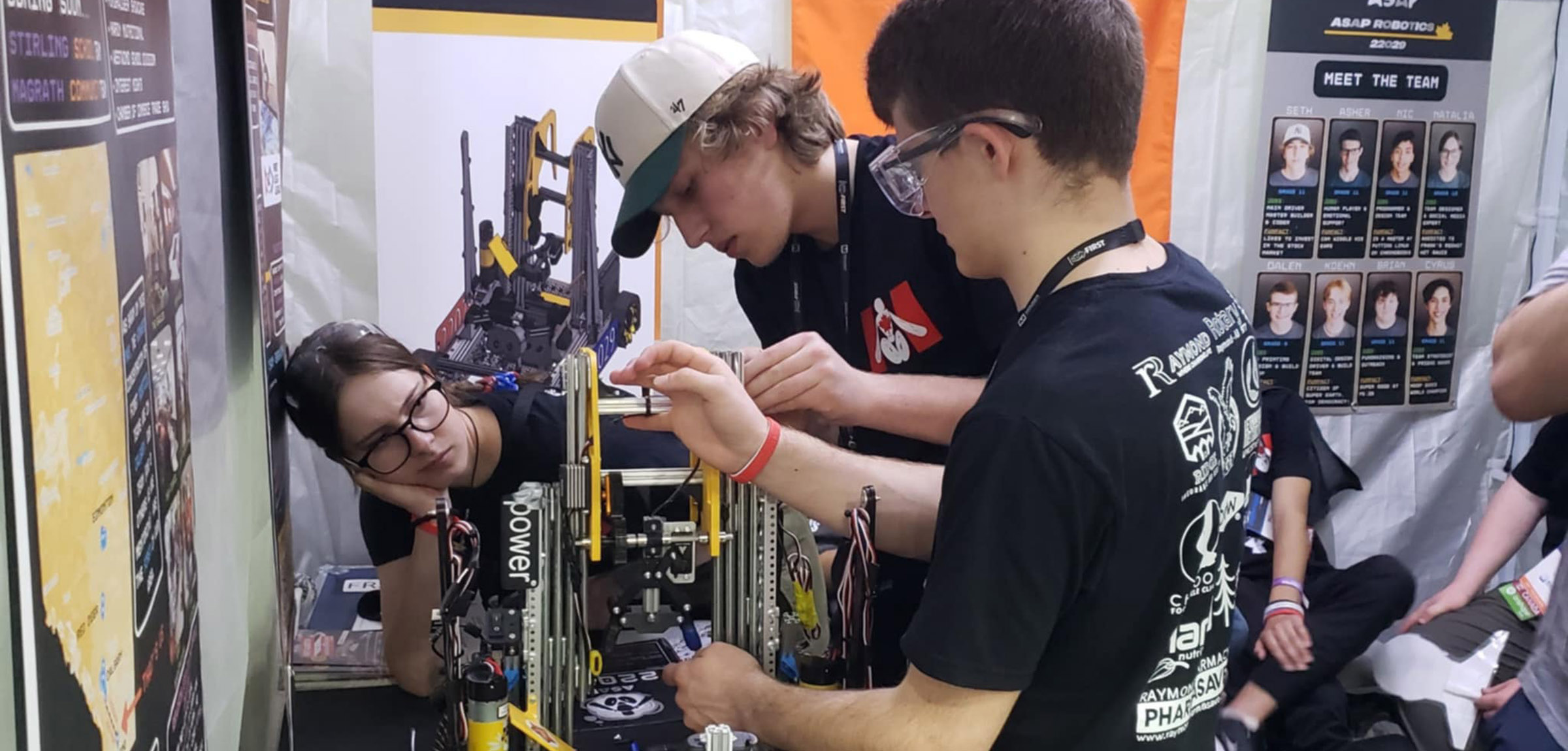 Students working on a robot in a shop