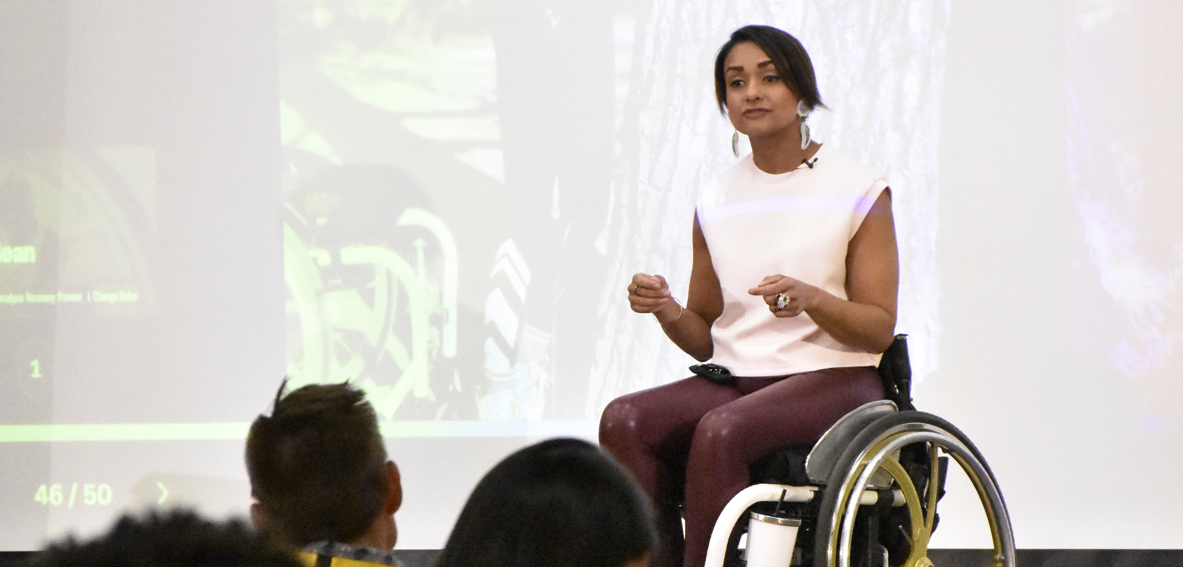 Women in wheelchair speaking in front of conference