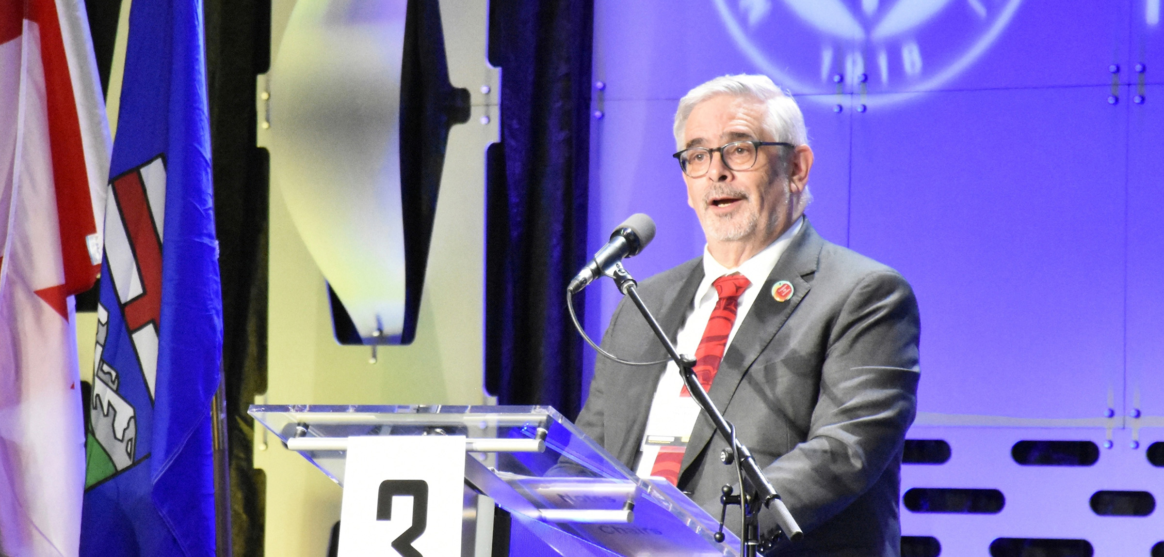 ATA Executive secretary speaks at a podium