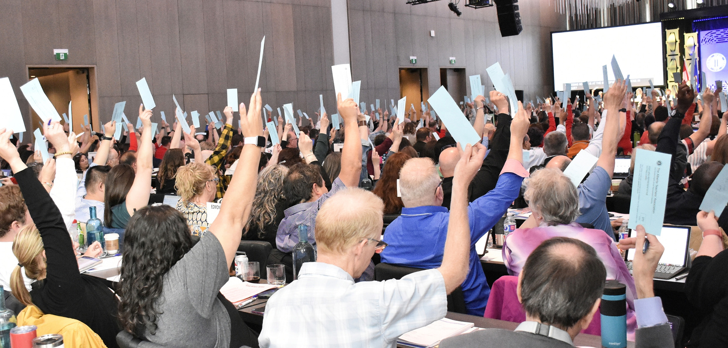 ARA delegates raise their hands in a vote