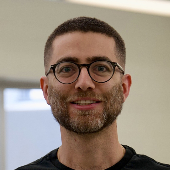 Young man with round glasses and black shirt