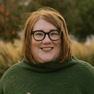 Red haired women in green sweater