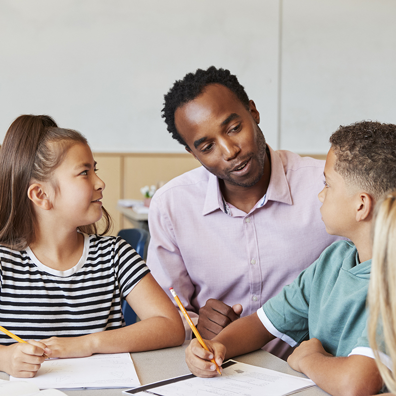 Teacher seated with students
