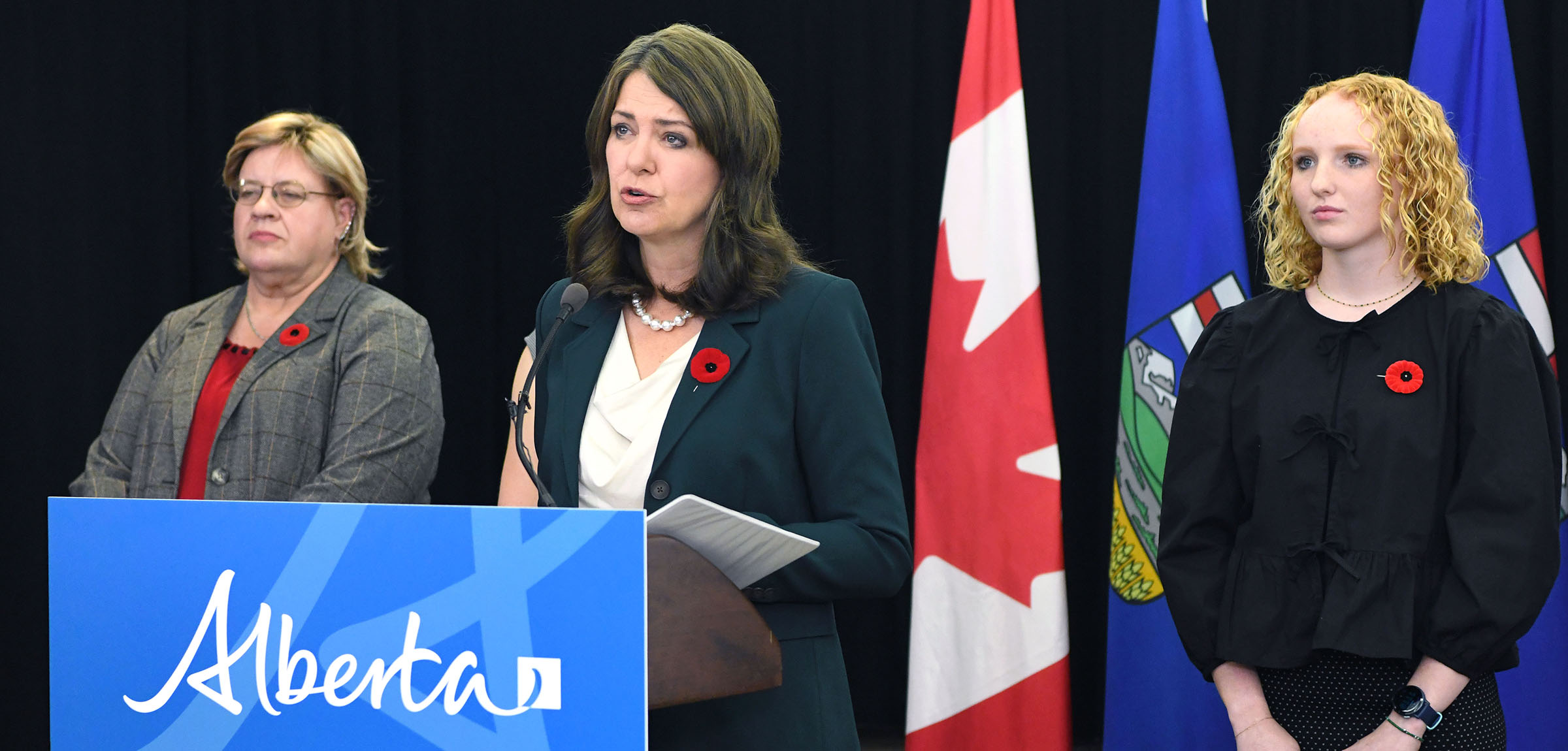 Premiere Smith at a podium speaking about changes to the Education Act