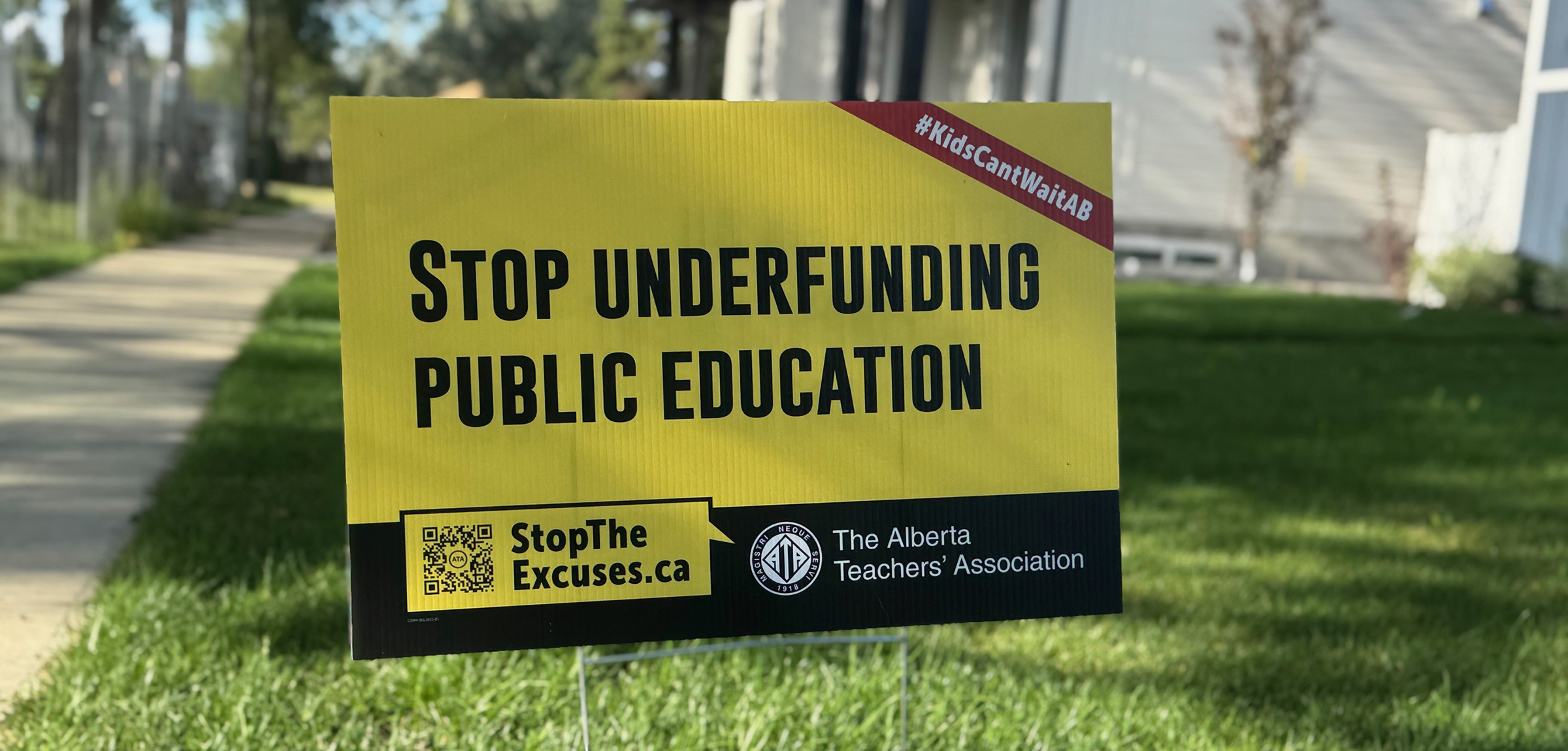 A lawn sign that says "Stop underfunding public education"