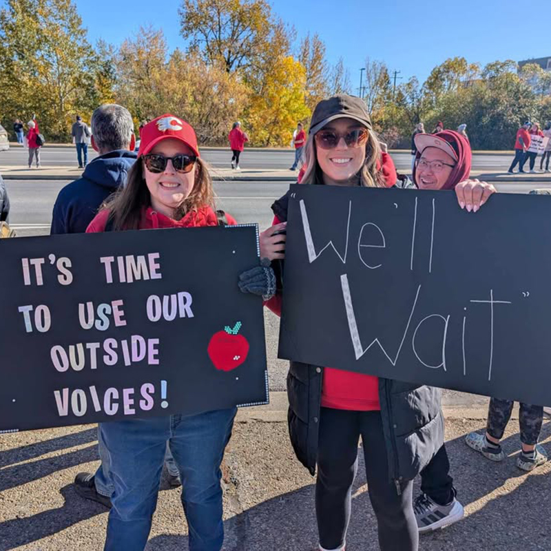 Two teachers at a rally in Red Deer