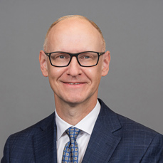 A smiling man with glasses