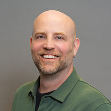 A bearded, bald man