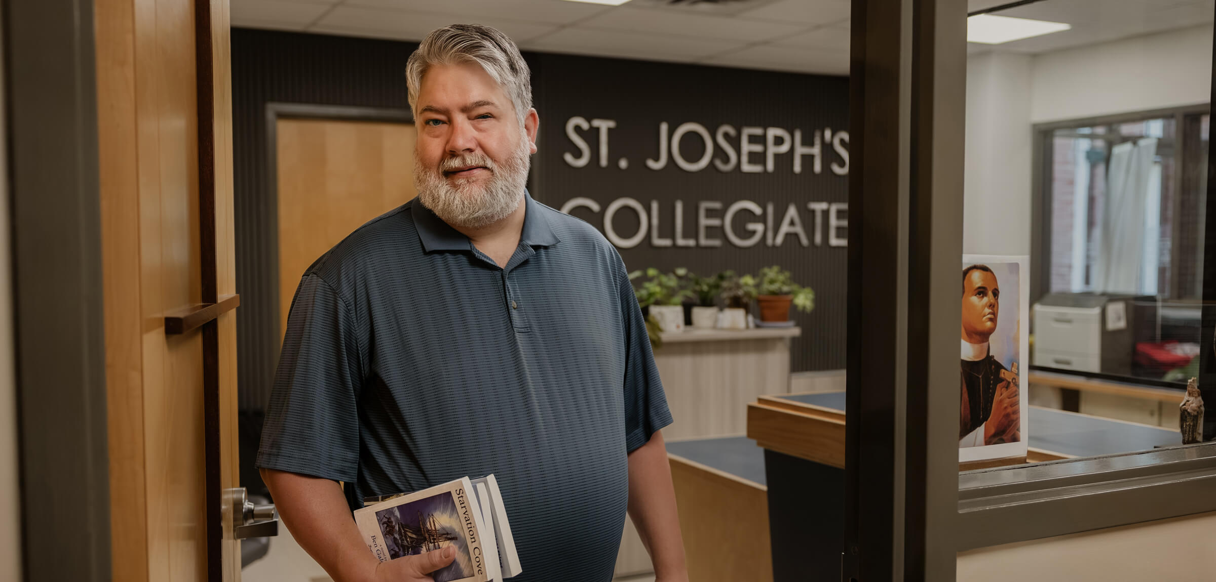 Ben Galeski wears a grey shirt as he steps outside of the school office