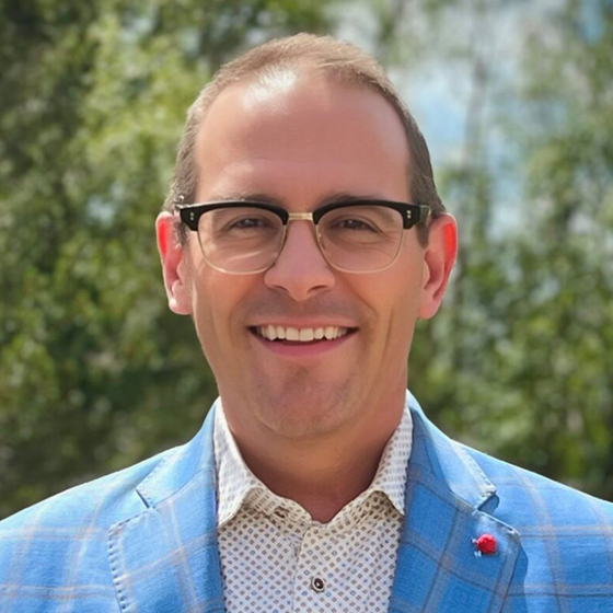 Man in blue suit standing outside