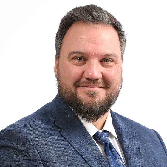 Portrait of a bearded man in a blue suit