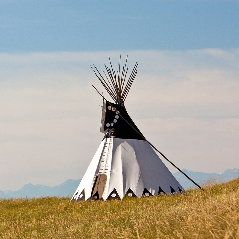 Tipi on the great plains with mountains in the background