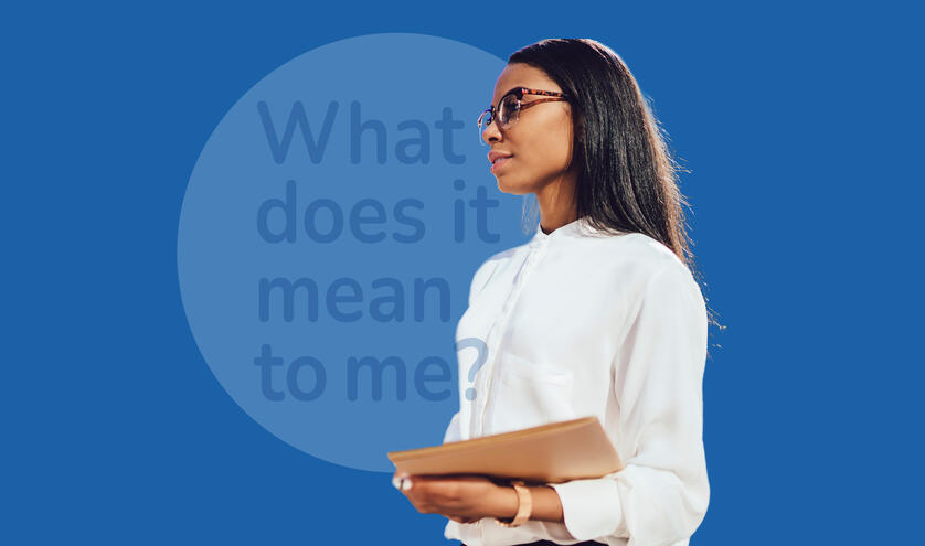 Women wearing glasses and white blouse holding a book