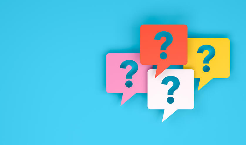 four colourful speech bubbles with question marks