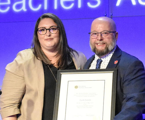 Women accepts certificate from PEC members