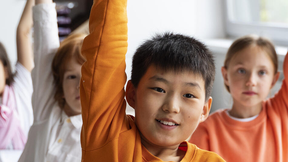 students raising their hands
