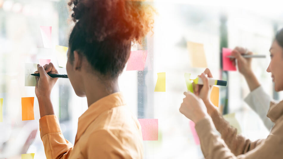 Women writing on post-it notes