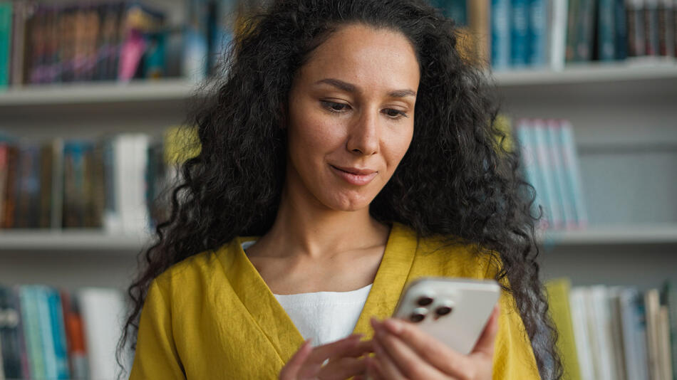 Women on phone in library