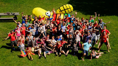 Ariel photo of campers in front of a giant inflated firefly