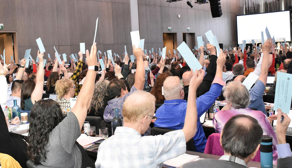 ARA delegates raise their hands in a vote