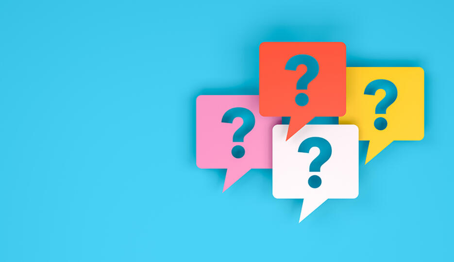 four colourful speech bubbles with question marks