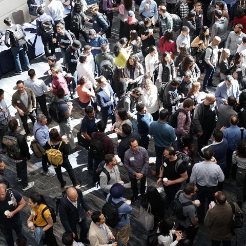 Crowd of people gathered in a trade show hall