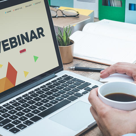 Laptop with title screen of a webinar