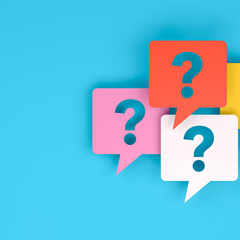 four colourful speech bubbles with question marks