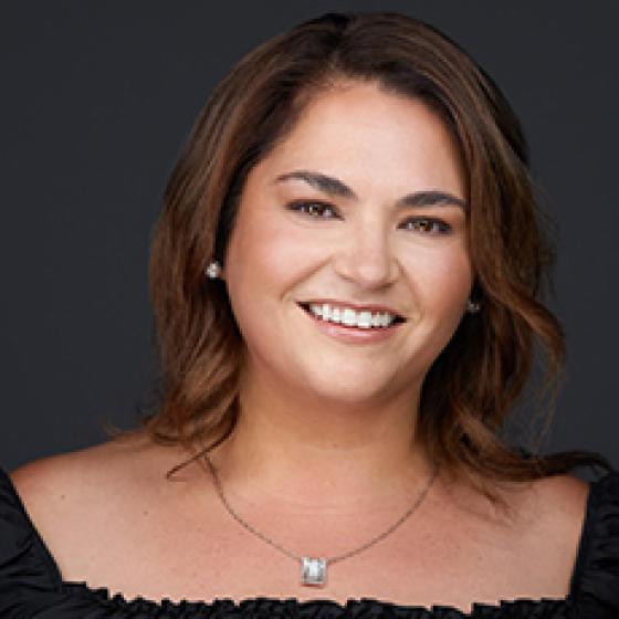 Headshot of Provincial Executive Council member Carmen Glossop in front of a dark background.