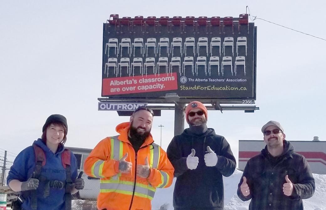 People giving a thumbs up after the ATA billboard is complete