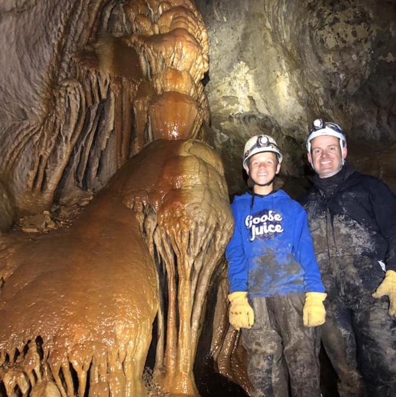 Two people standing in a cave