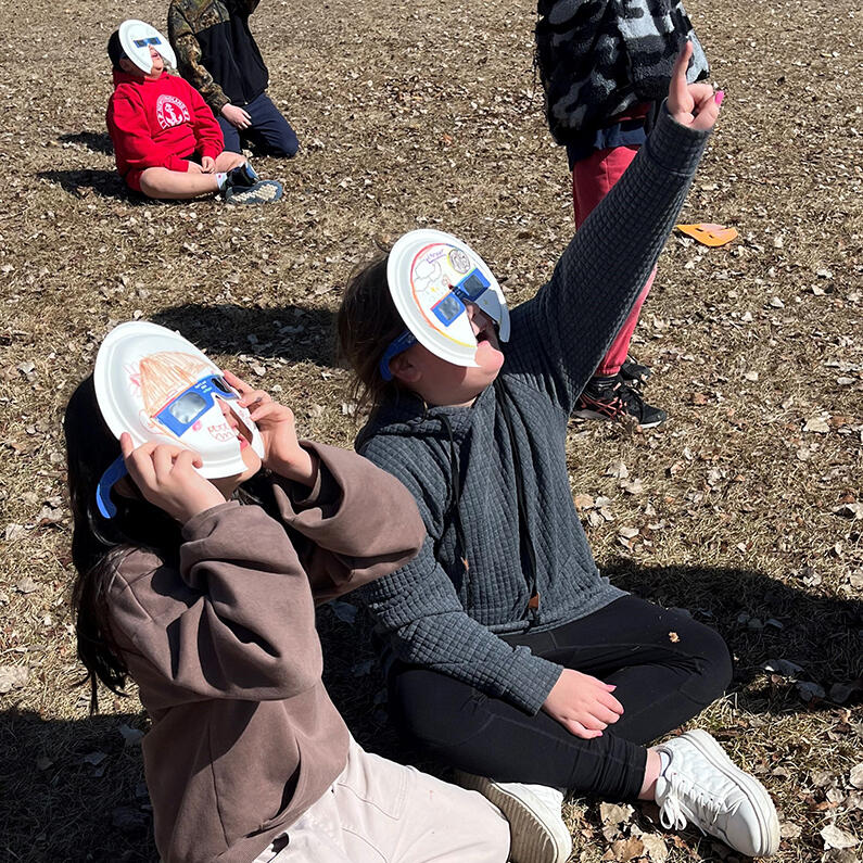 Children watch the solar eclipse through protective eyewear