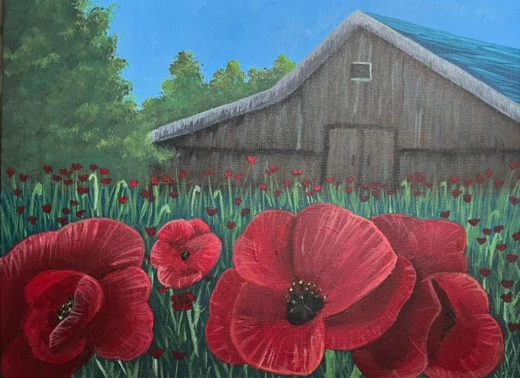 field of poppies in front of a barn