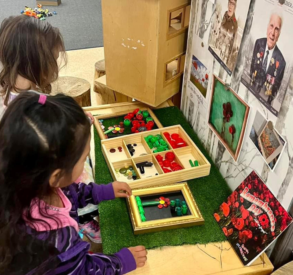 Over the shoulder of two students as they create poppies 